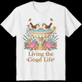 Vintage bird bath with sparrows splashing and flowers and text Living the Good Life